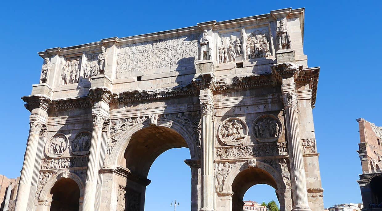 A view of the famous arch in Rome with blue sky in the background