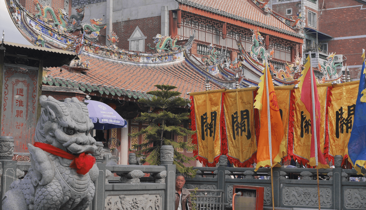 Street scene in Southern Chinese city - lone man looking at camera